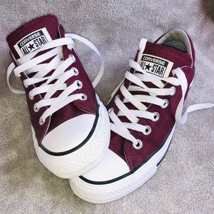 Maroon Chuck Taylor all-star Converse shoes.